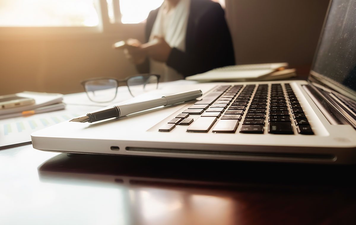 kare resimler_0010_business-concept-with-copy-space-office-desk-table-with-pen-focus-analysis-chart-computer-notebook-cu